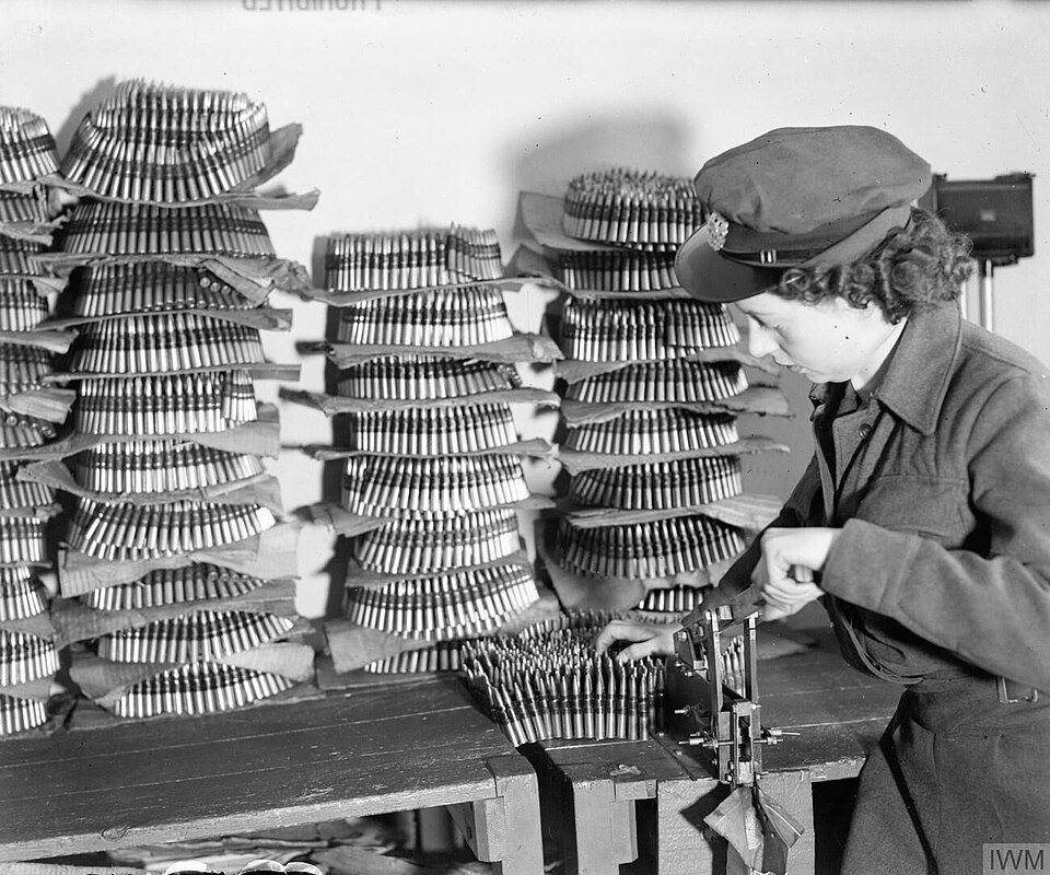 A Waaf Armourer Belting Up Ammunition For a Lancaster Bomber CH12285